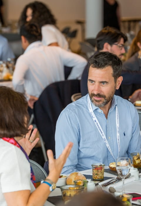 people sitting down to lunch, talking and eating