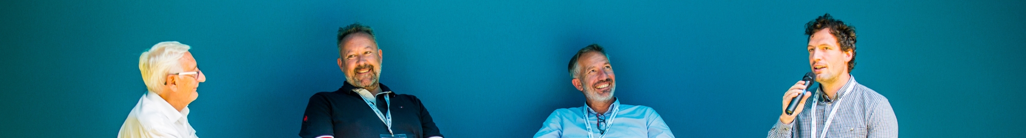 Smiling, professional speakers discuss expert topics