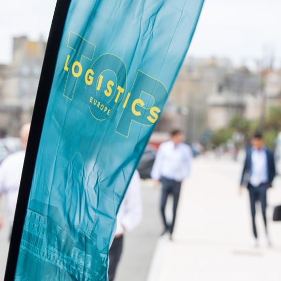Floating banner of top logistics europe, with people in suits marching towards Quai Saint-Malo.