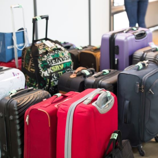  Numerous suitcases gathered and kept safe in the event's checkroom, with a dedicated hostess. 