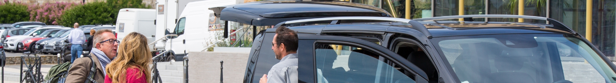 Group of people talking to a van driver next to his vehicle in front of Top Logistics Europe.