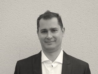 Portrait of Julien CENSIER, a smiling, professional member of the sales team.