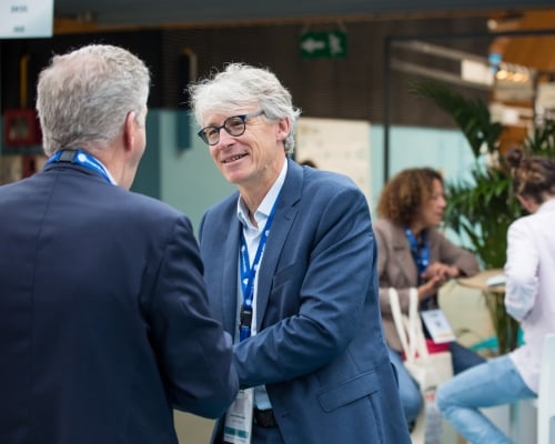 Two businessmen shake hands at Top Logistics